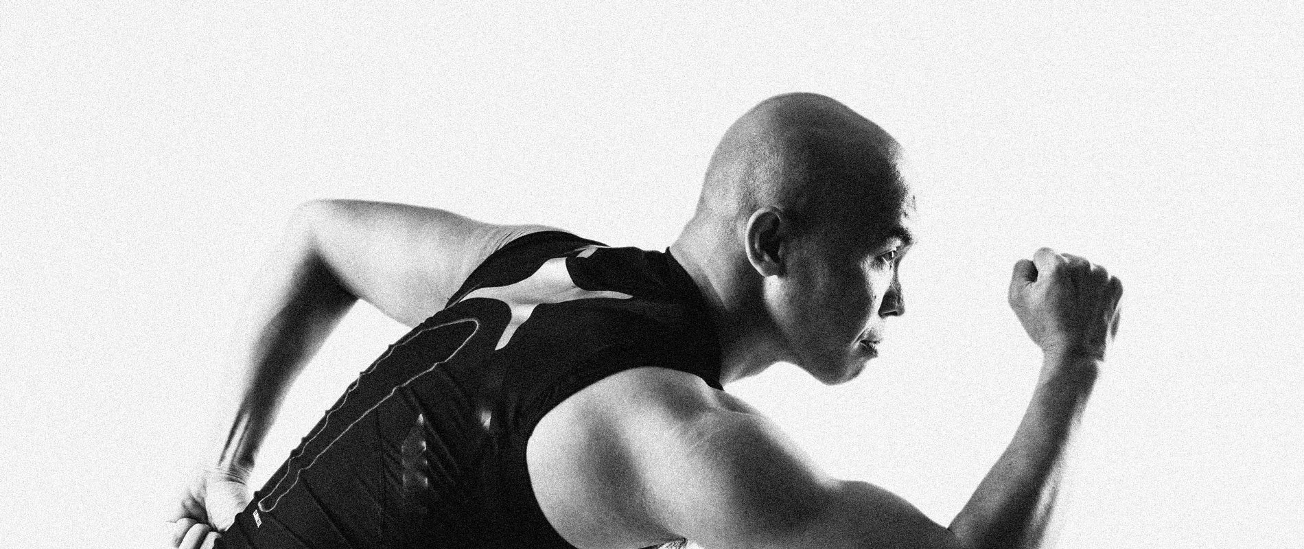 Level Up athlete in a running stance, black and white